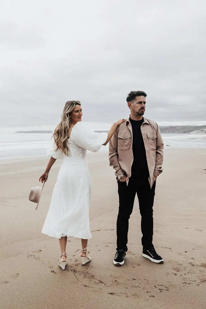 Couple celebrating engagement on Whitsand Bay beach in Cornwall