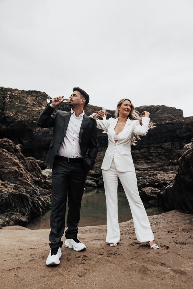 Couple celebrating engagement on Whitsand Bay beach in Cornwall