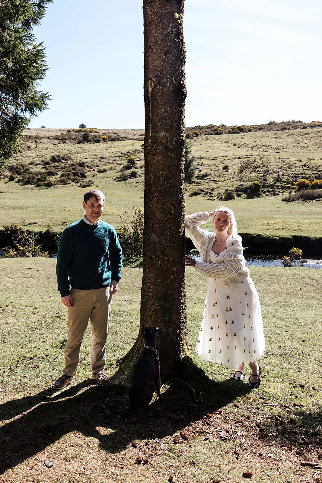 Engagement photoshoot in Dartmoor woodland with couple and their dog in a natural outdoor setting