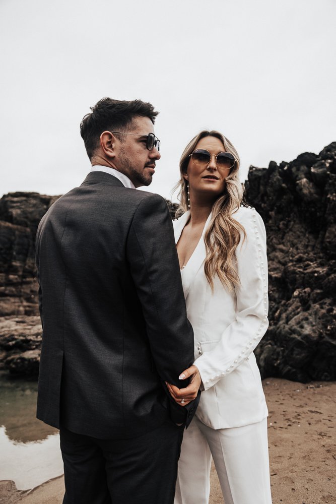 Couple celebrating engagement on Whitsand Bay beach in Cornwall