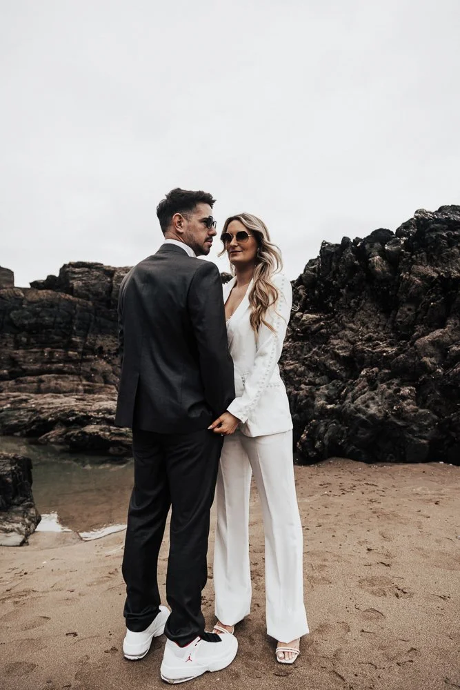 Couple celebrating engagement on Whitsand Bay beach in Cornwall