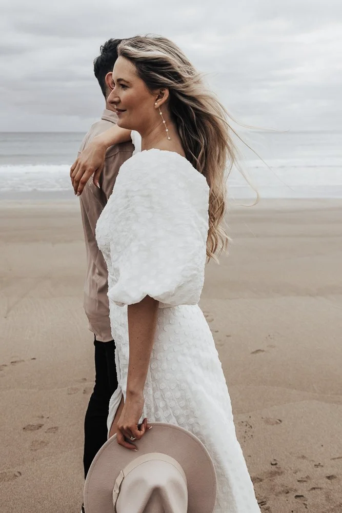 Couple celebrating engagement on Whitsand Bay beach in Cornwall
