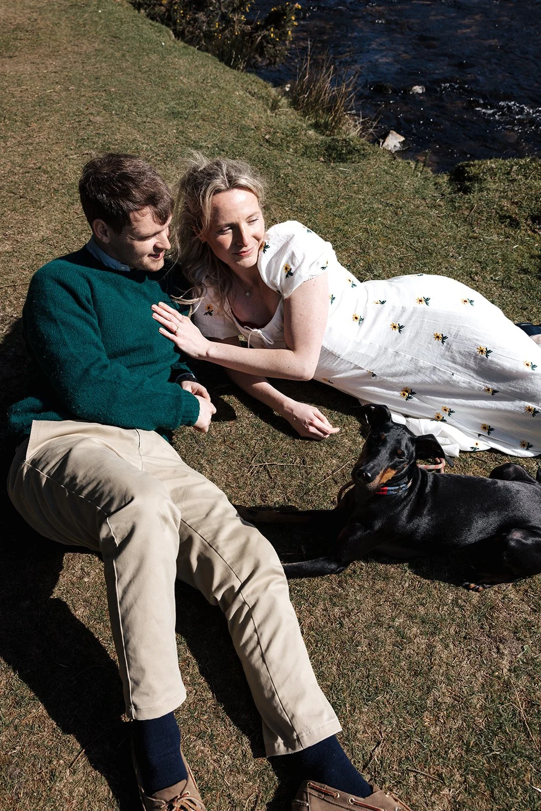 Engagement photoshoot in Dartmoor woodland with couple and their dog in a natural outdoor setting
