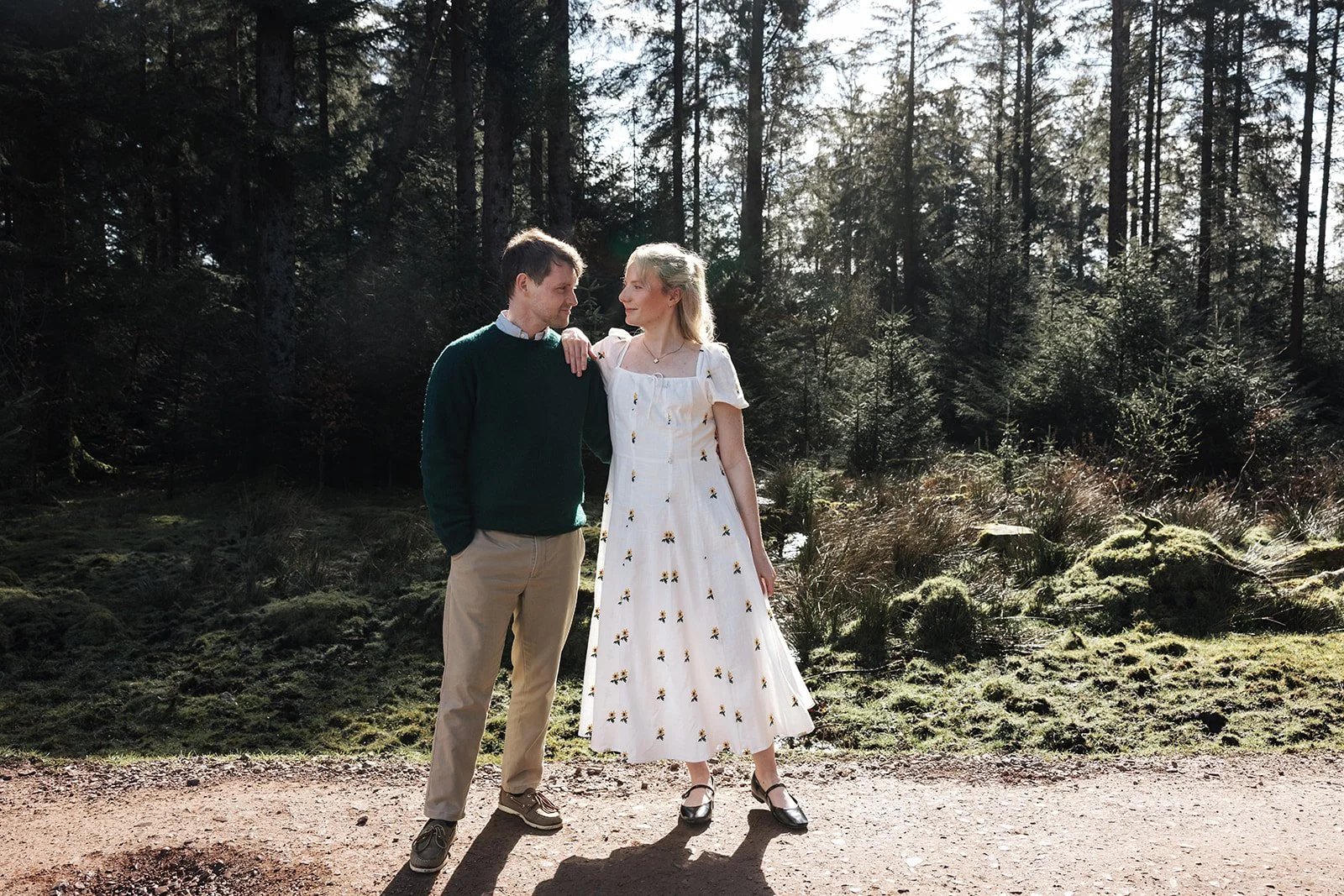 Engagement photoshoot in Dartmoor woodland with couple and their dog in a natural outdoor setting