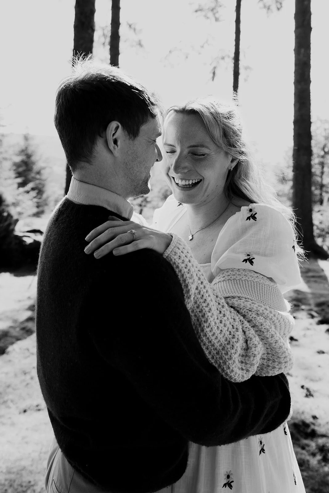 Engagement photoshoot in Dartmoor woodland with couple and their dog in a natural outdoor setting