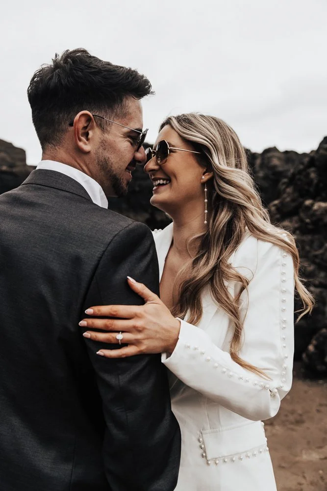 Couple celebrating engagement on Whitsand Bay beach in Cornwall