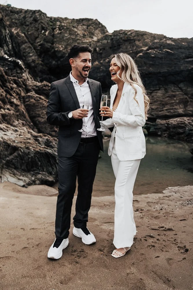 Couple celebrating engagement on Whitsand Bay beach in Cornwall