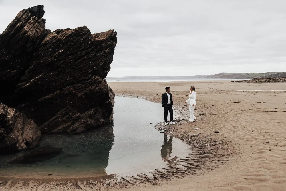 Couple celebrating engagement on Whitsand Bay beach in Cornwall