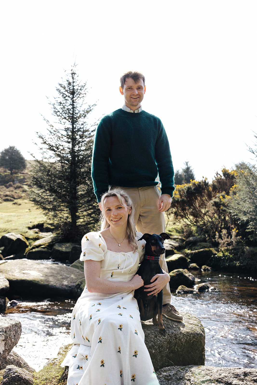 Engagement photoshoot in Dartmoor woodland with couple and their dog in a natural outdoor setting