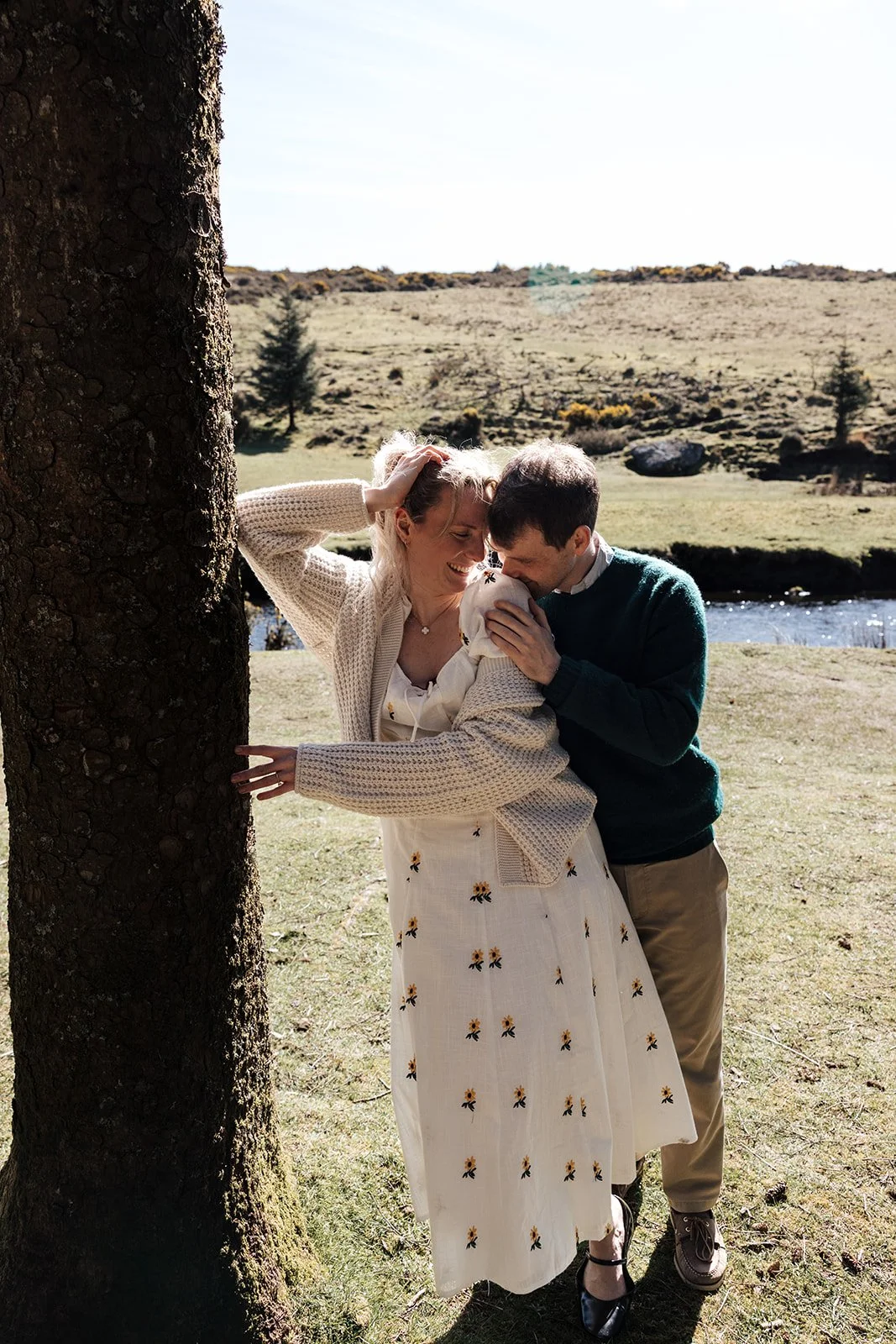 Engagement photoshoot in Dartmoor woodland with couple and their dog in a natural outdoor setting