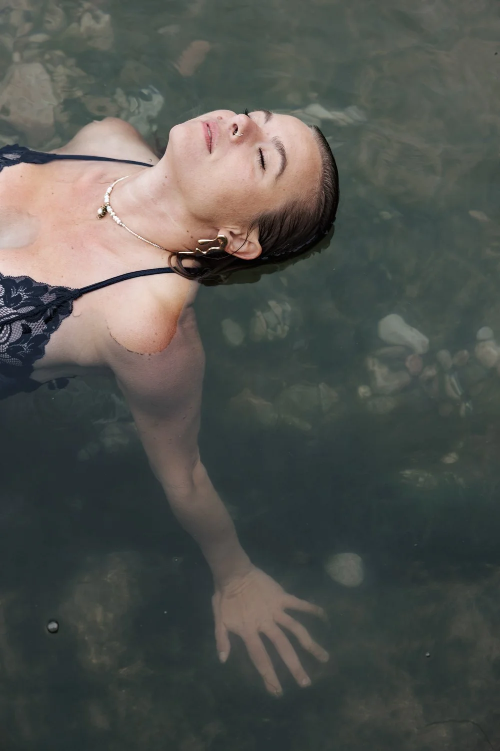 A woman having a self love confidence photoshoot in the sea in plymouth devon