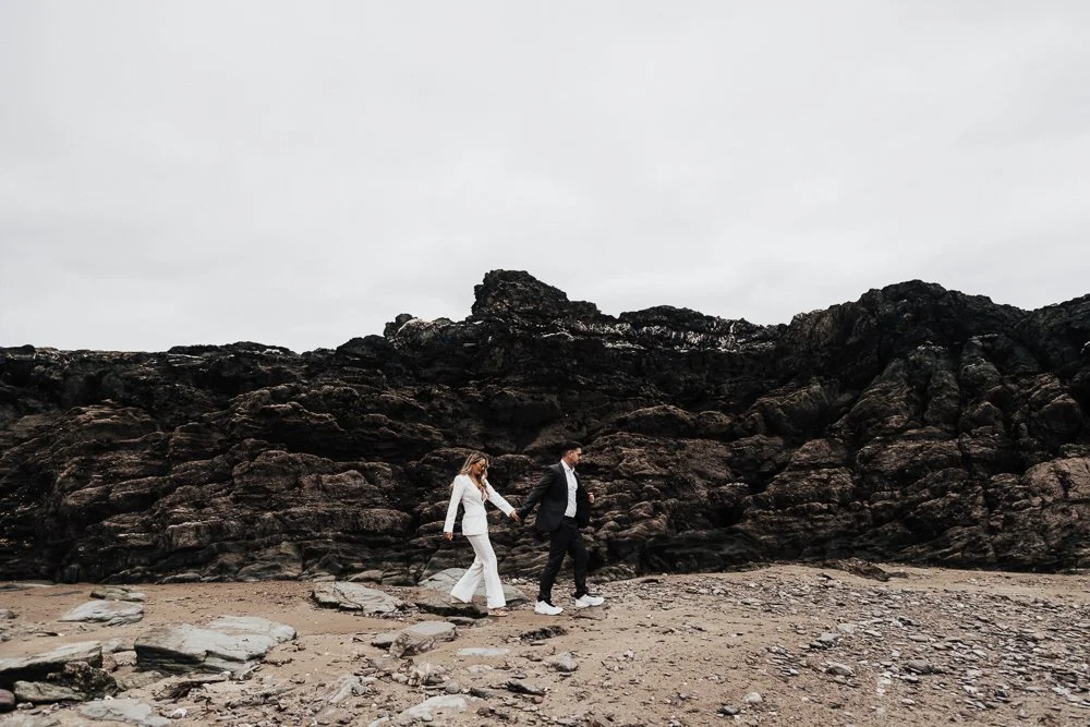 Couple celebrating engagement on Whitsand Bay beach in Cornwall