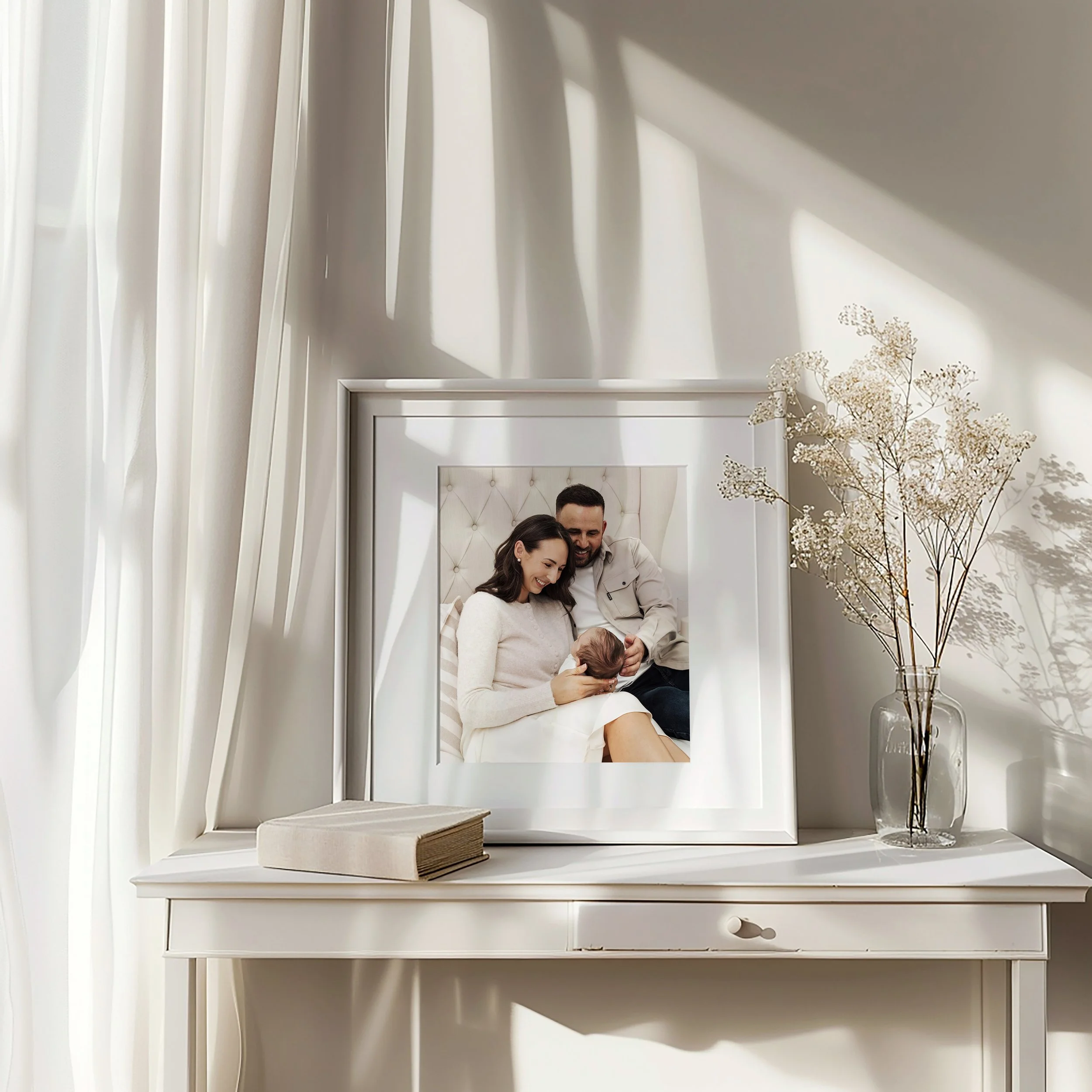 newborn family photo in a frame by a luxury photographer from plymouth devon