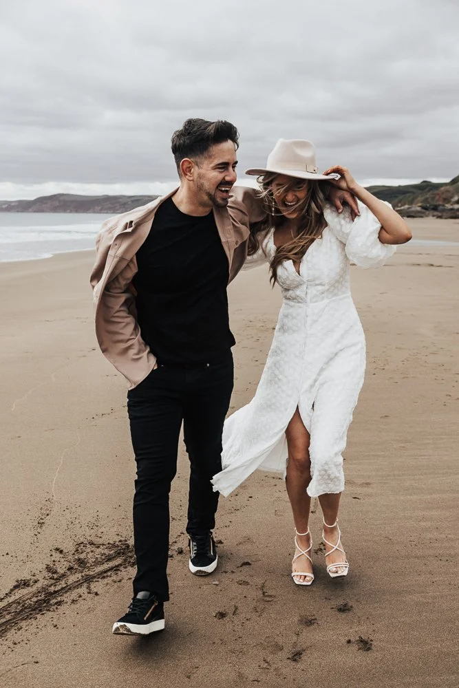 Couple celebrating engagement on Whitsand Bay beach in Cornwall