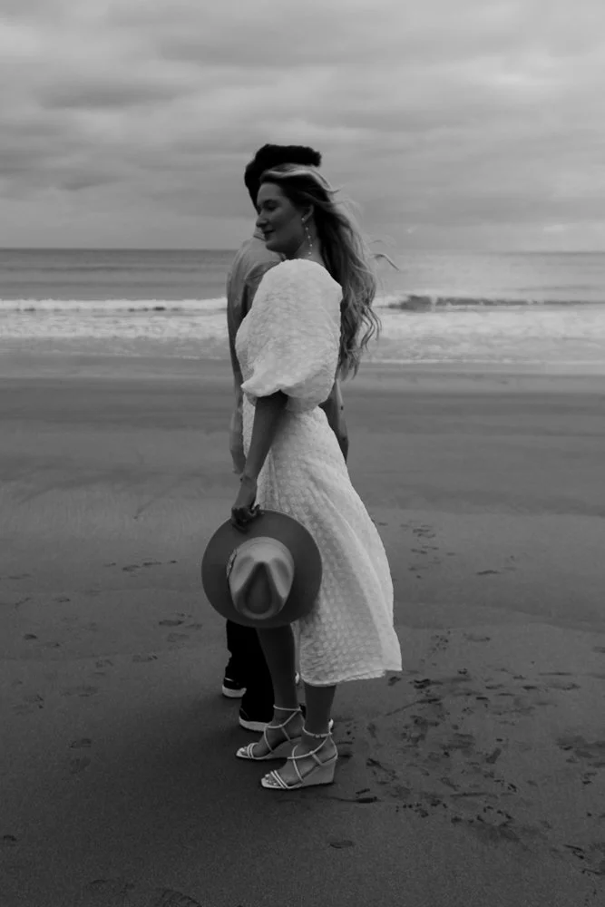 Couple celebrating engagement on Whitsand Bay beach in Cornwall