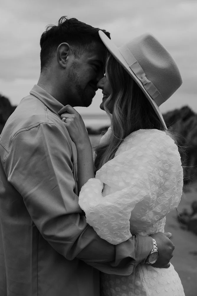 Couple celebrating engagement on Whitsand Bay beach in Cornwall