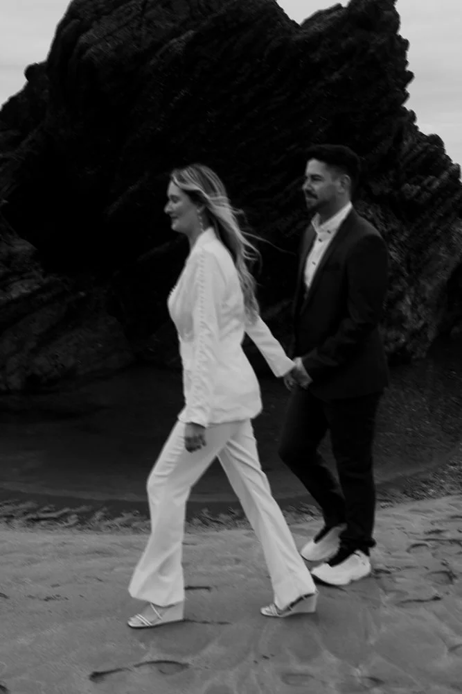 Couple celebrating engagement on Whitsand Bay beach in Cornwall