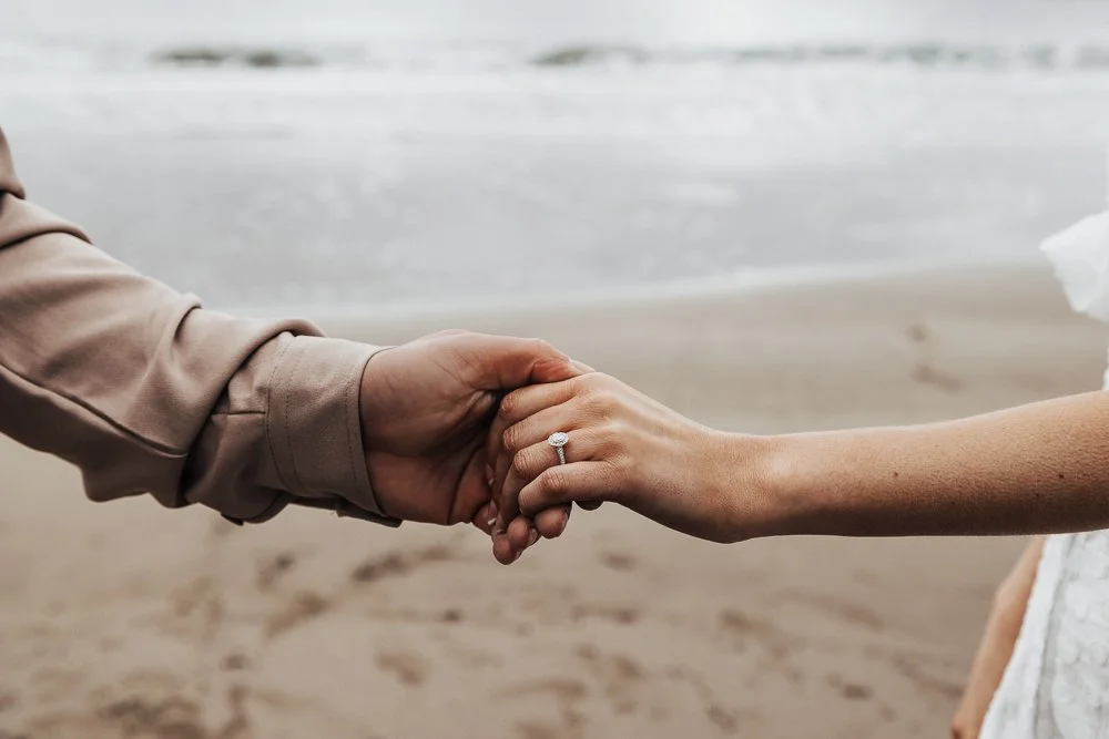 Couple celebrating engagement on Whitsand Bay beach in Cornwall