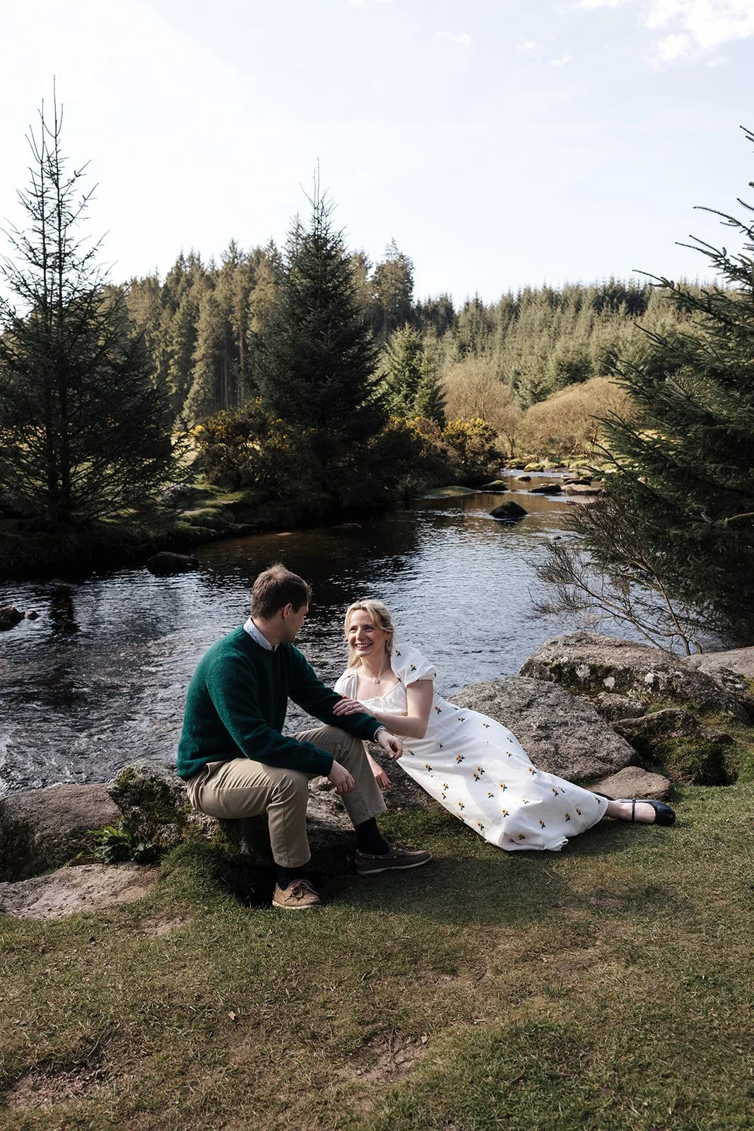 Engagement photoshoot in Dartmoor woodland with couple and their dog in a natural outdoor setting