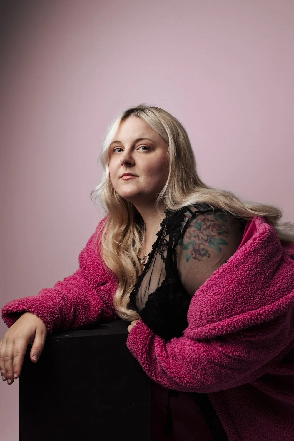 Woman wearing a bright pink outfit during a women's portrait photography session in Plymouth.