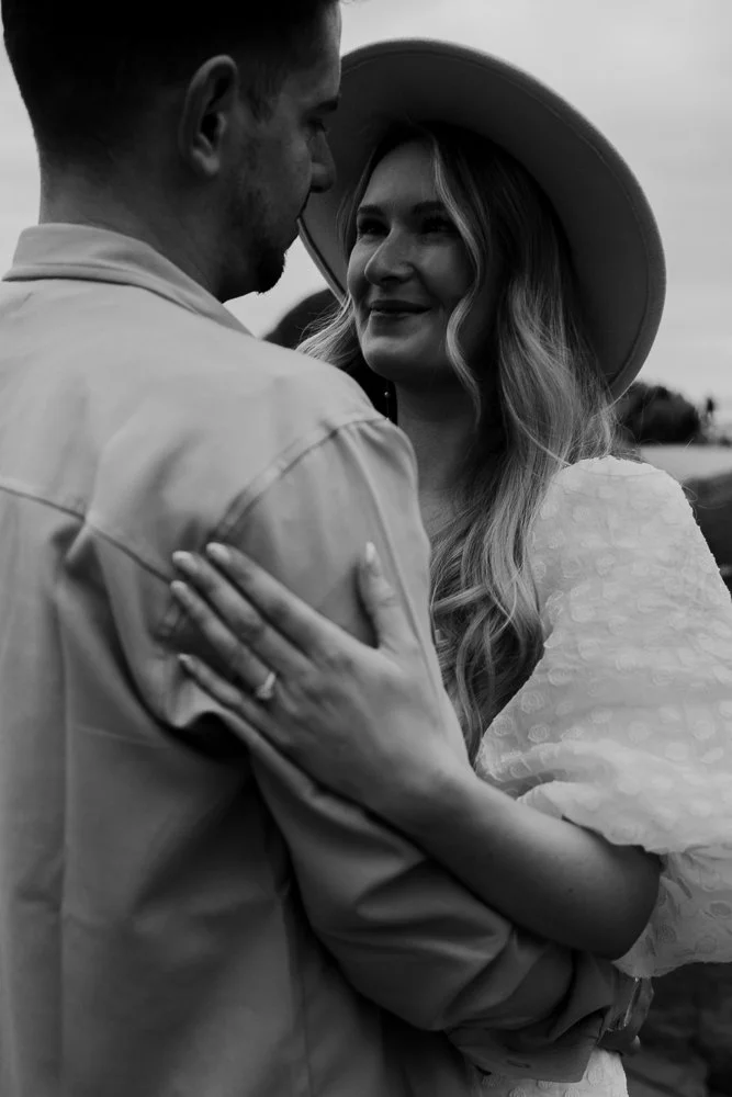 Couple celebrating engagement on Whitsand Bay beach in Cornwall