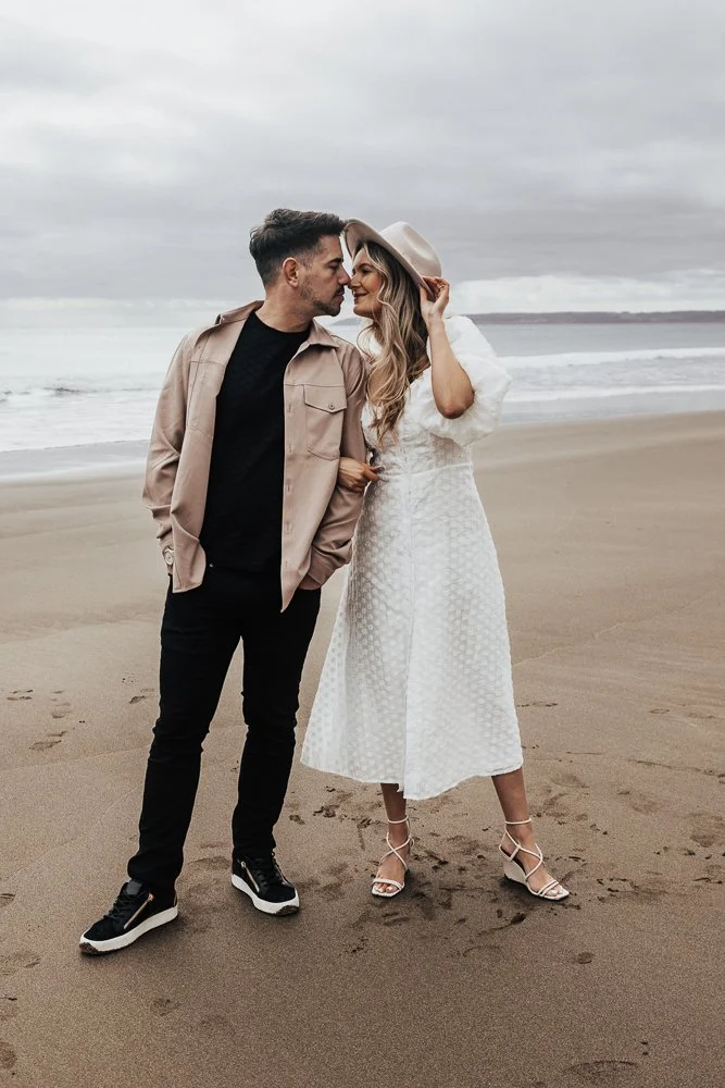 Couple celebrating engagement on Whitsand Bay beach in Cornwall