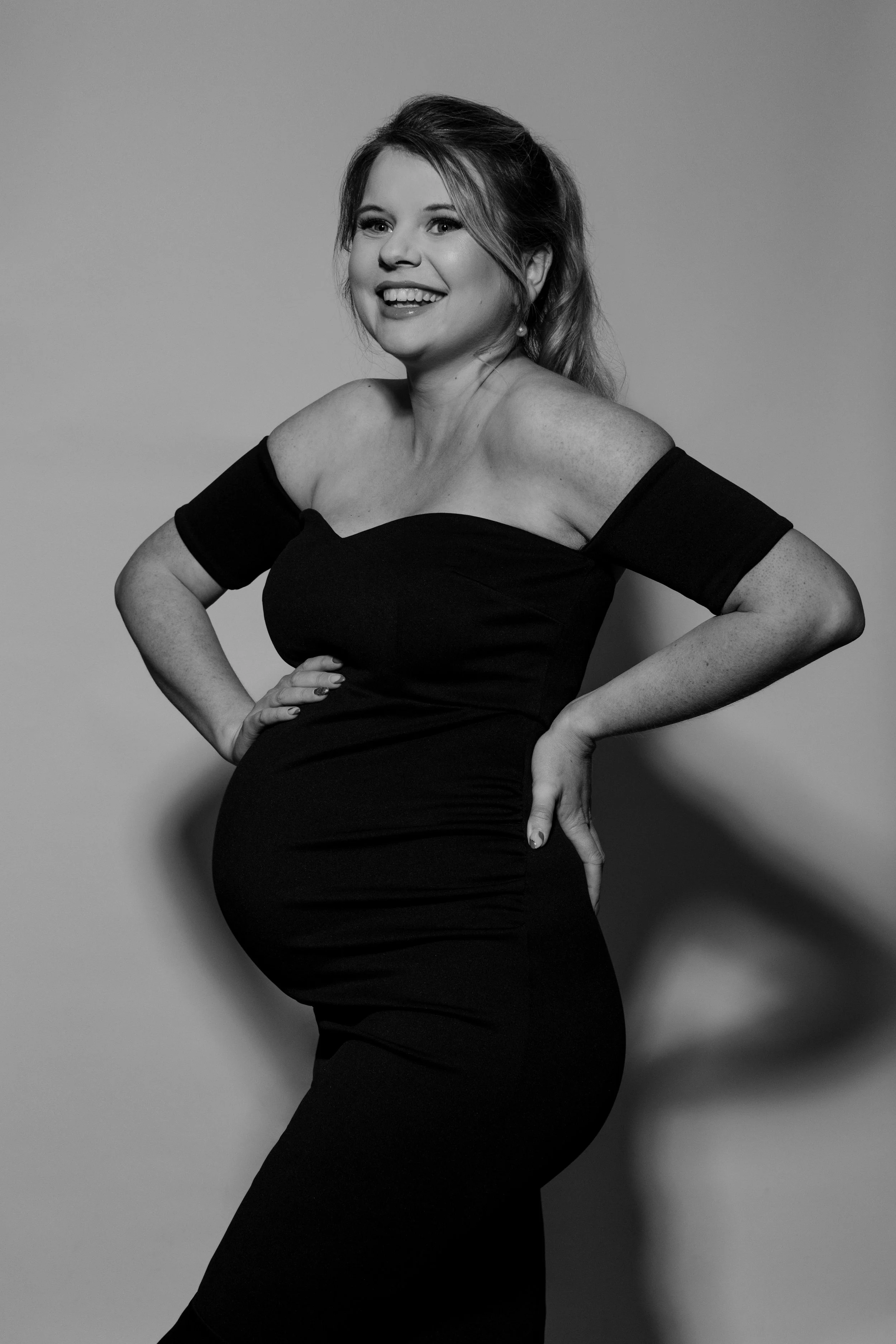 Elegant studio maternity portrait of an expectant mother in Plymouth, photographed with natural posing.