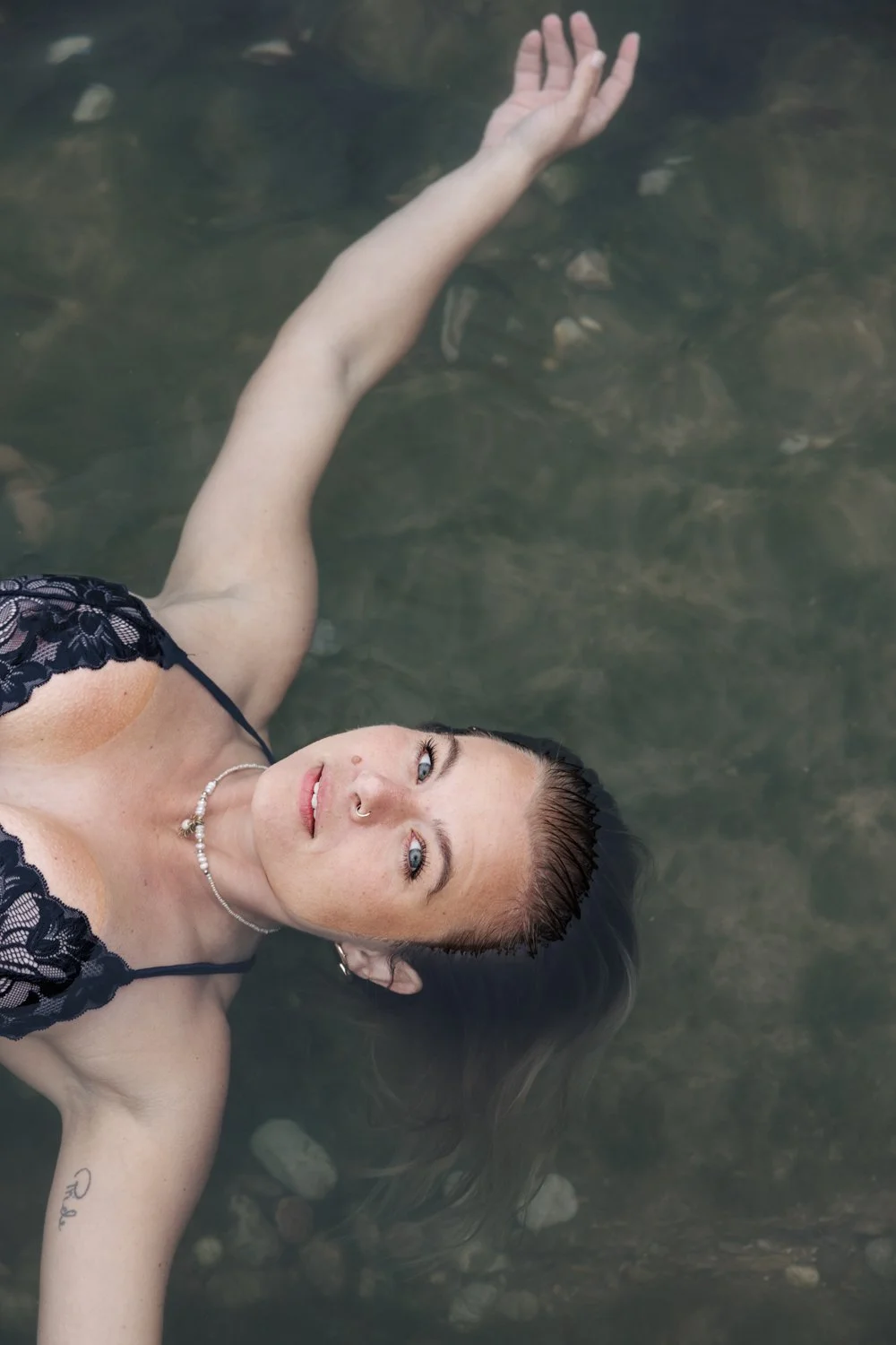 Woman standing in the sea during a self-love portrait session in Plymouth, Devon.
