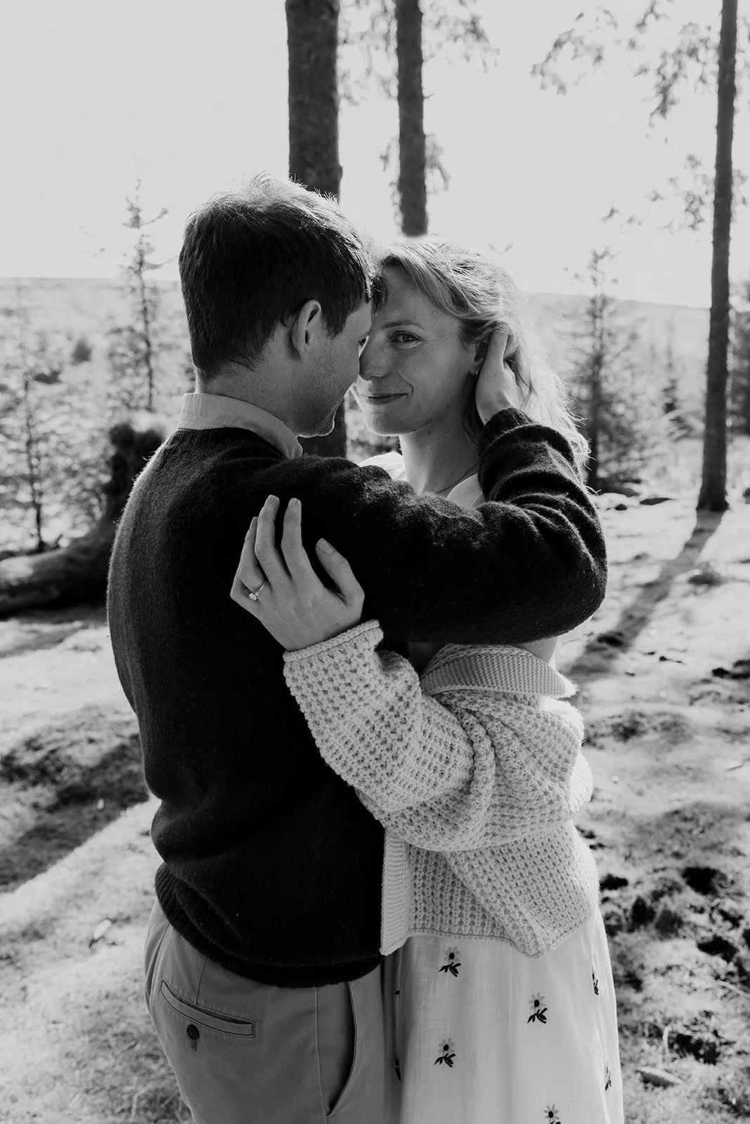 Engagement photoshoot in Dartmoor woodland with couple and their dog in a natural outdoor setting