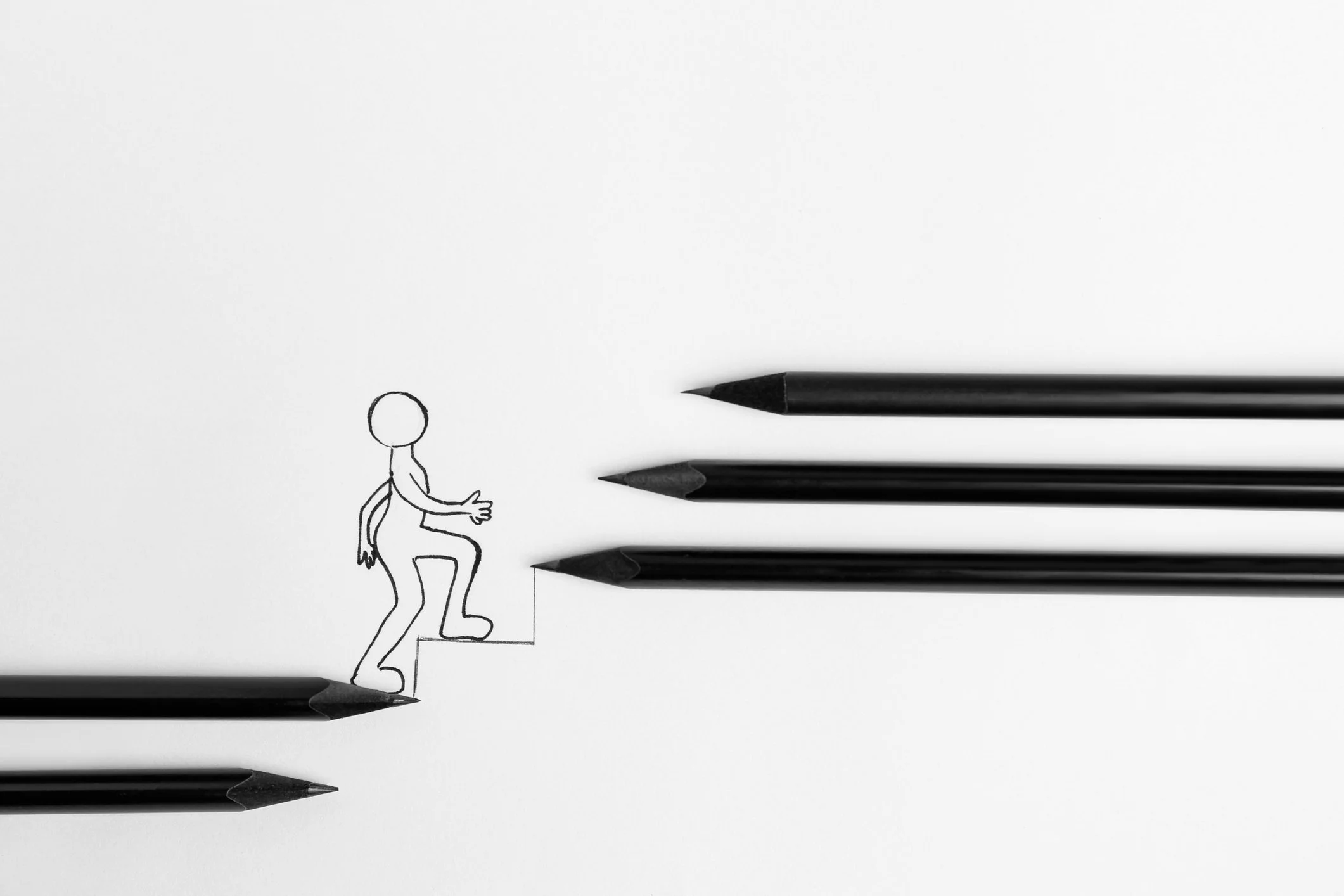 A line art person walking up stairs drawn by pencils
