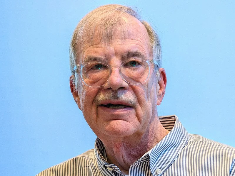 photo of Alan Bauer against a light blue background