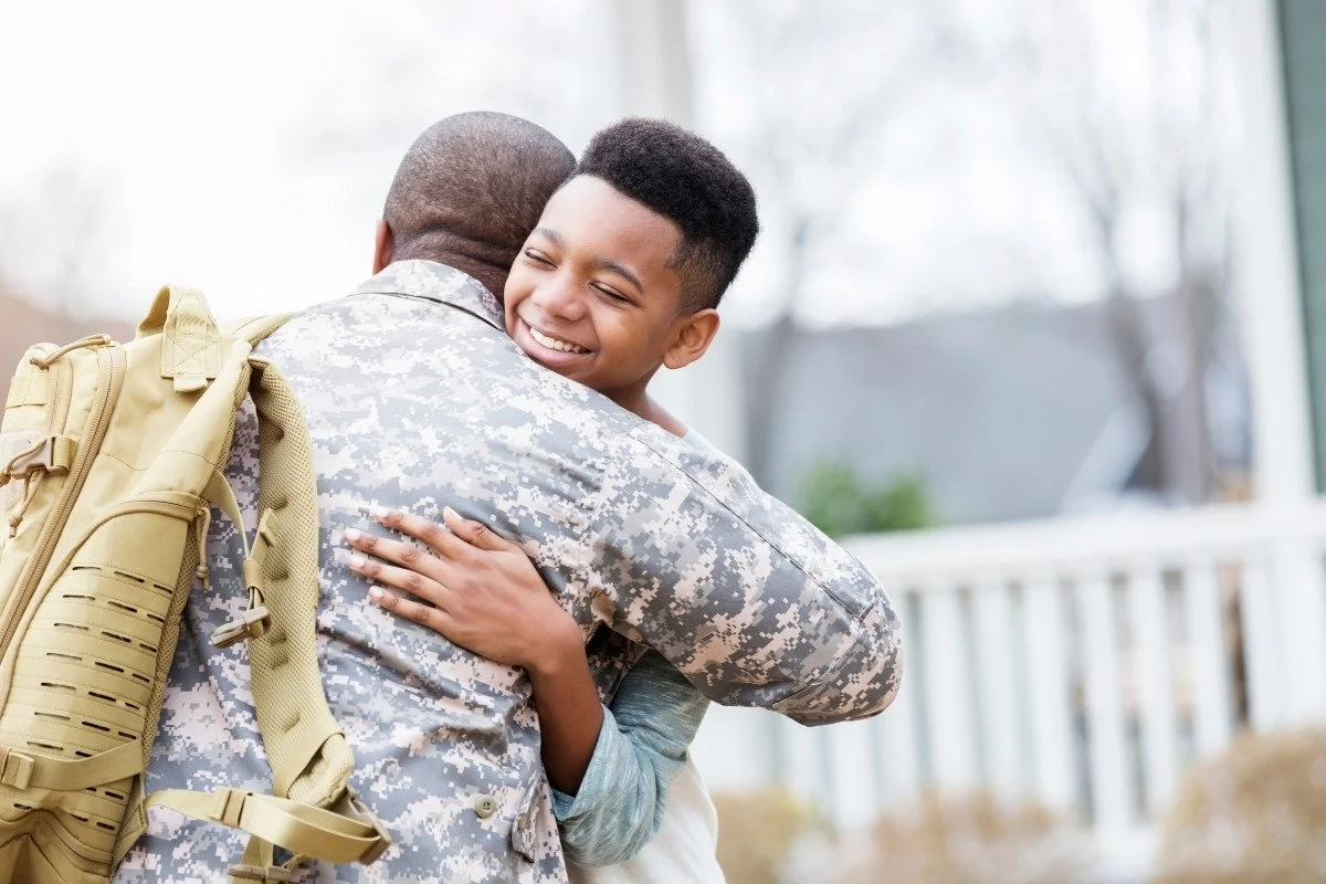 a retunring military veteran hugs his son