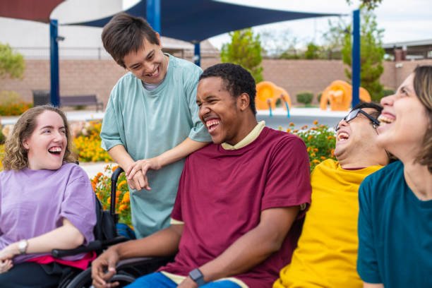 People with intellectual disabilities sitting together and laughing