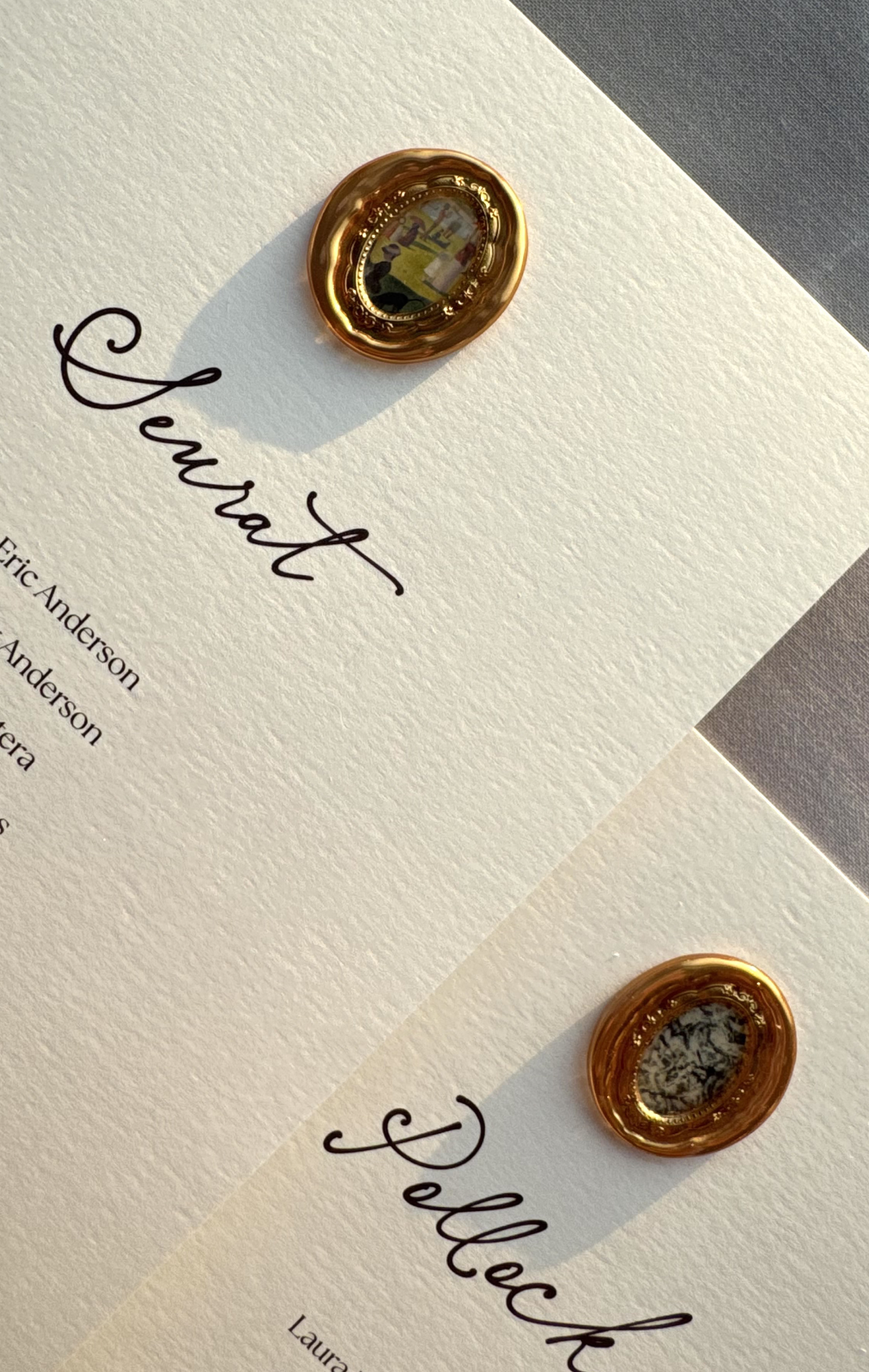 Custom wedding seating escort cards featuring miniature gold-framed artwork wax seals, hand-finished for an elegant Art Institute of Chicago wedding.