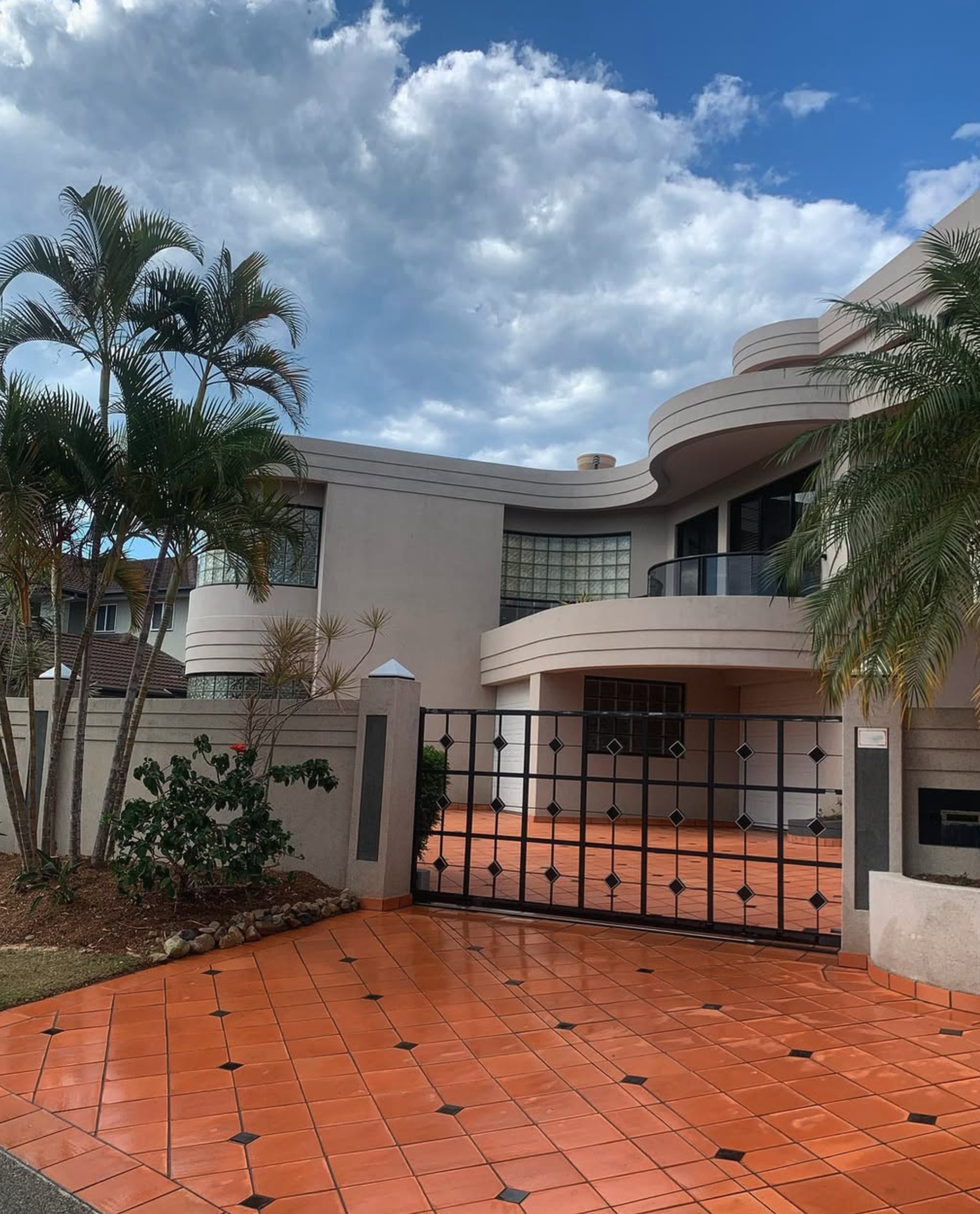 Blackmore's Pressure and Window Cleaning - Full residential exterior wash-down, window clean and pressure washing driveway and external surrounds of modern home with curved architecture and large glass panels