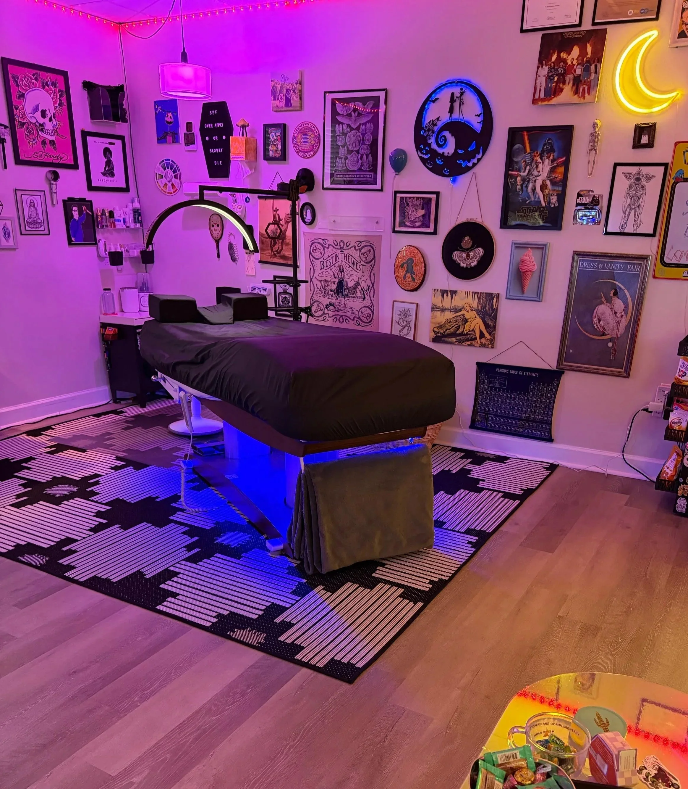 hydraulic adjustable treatment table surrounded by low colorful light , eclectic decor