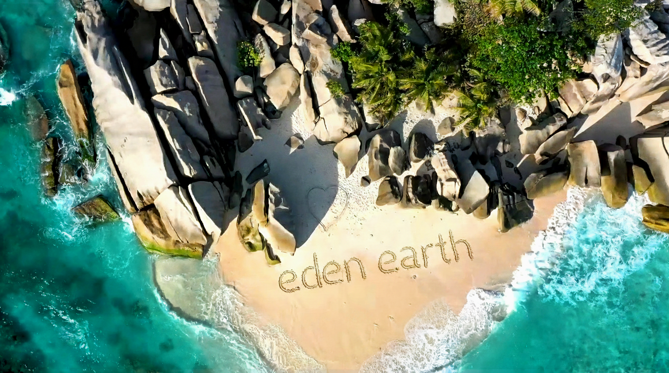 Aerial view of a secluded, pristine beach cove with turquoise water and large rocks. The words "Eden earth" is carved into the white sand below a small, hand-drawn hear