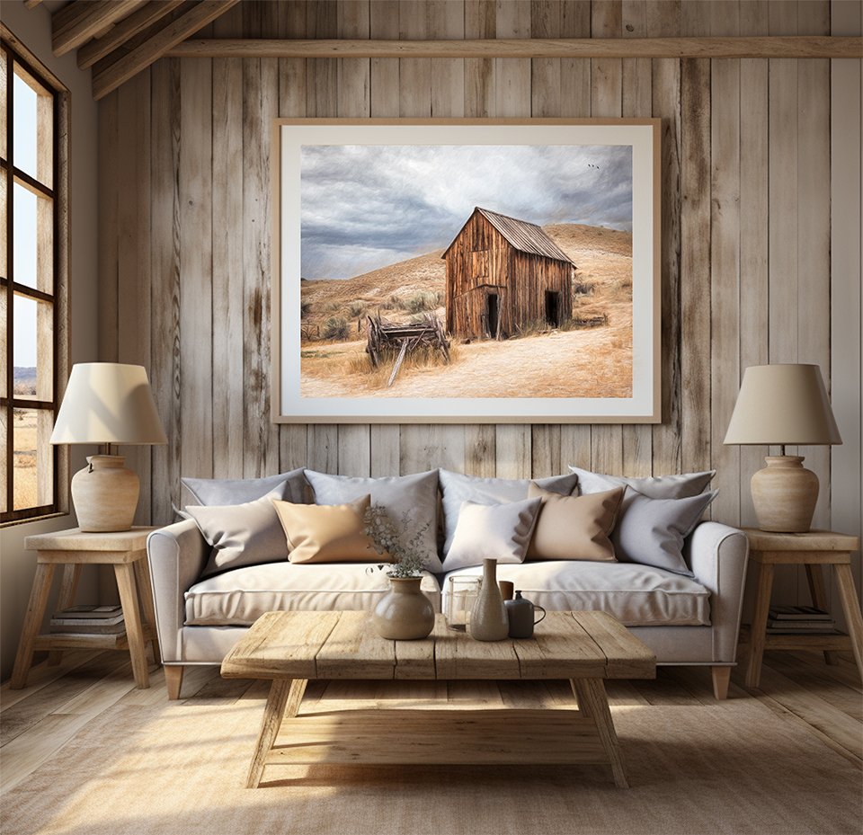 Framed western barn wall art displayed above a sofa in a cozy living room with wood walls, neutral tones, and rustic decor.