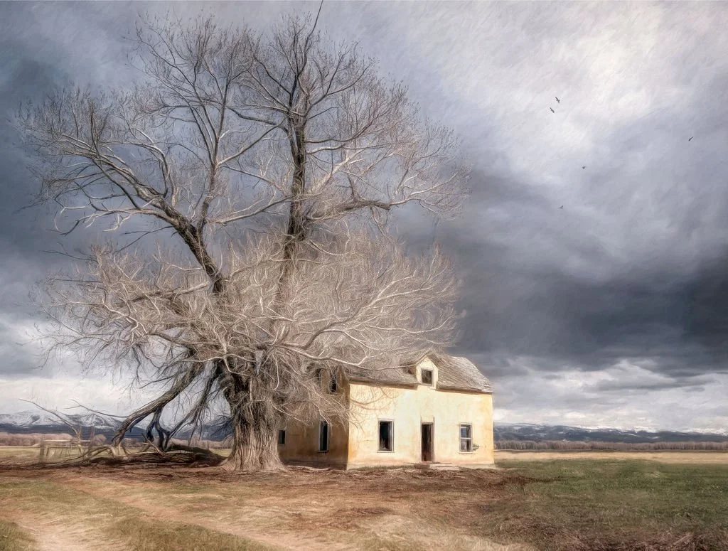 ABANDONED YELLOW FARMHOUSE SHELTERED BY A MASSIVE LEAFLESS TREE UNDER A DRAMATIC STORMY SKY