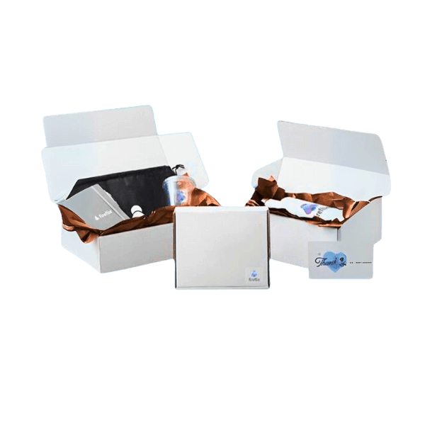 Two open white boxes with brown tissue paper inside, containing various electronic devices and accessories, on a black background.