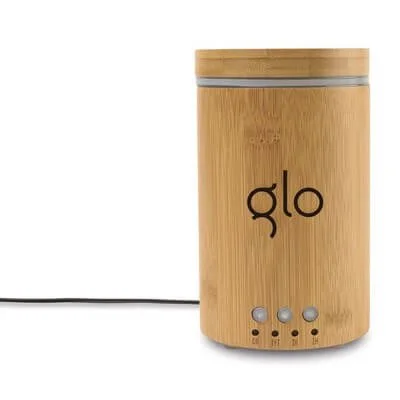 Bamboo aromatic oil diffuser shown operating on a clear tabletop.