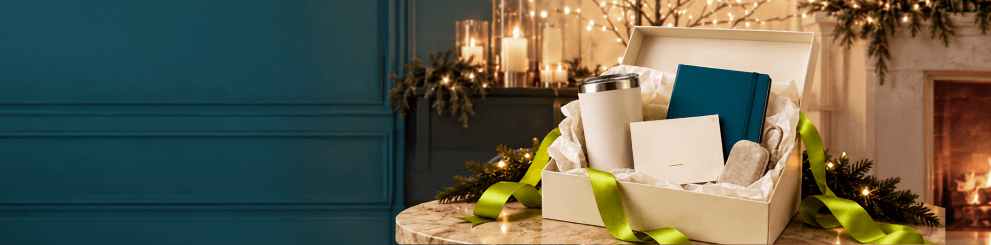 Custom corporate gift box featuring branded drinkware, a notebook, personalized stationery, and coordinated holiday packaging.