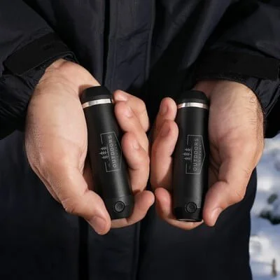 Pair of compact handwarmers shown together with charging function indicated.