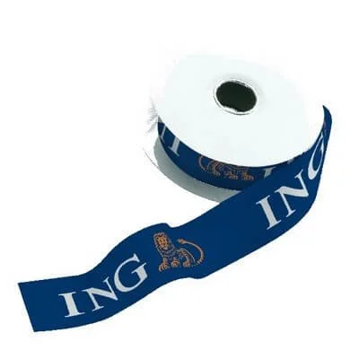 everal colorful satin ribbon rolls and loose ribbon samples printed with repeating logos and messages