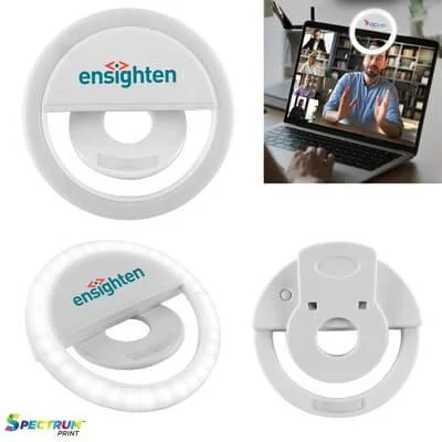 Clip-on ring light positioned beside a smartphone.
