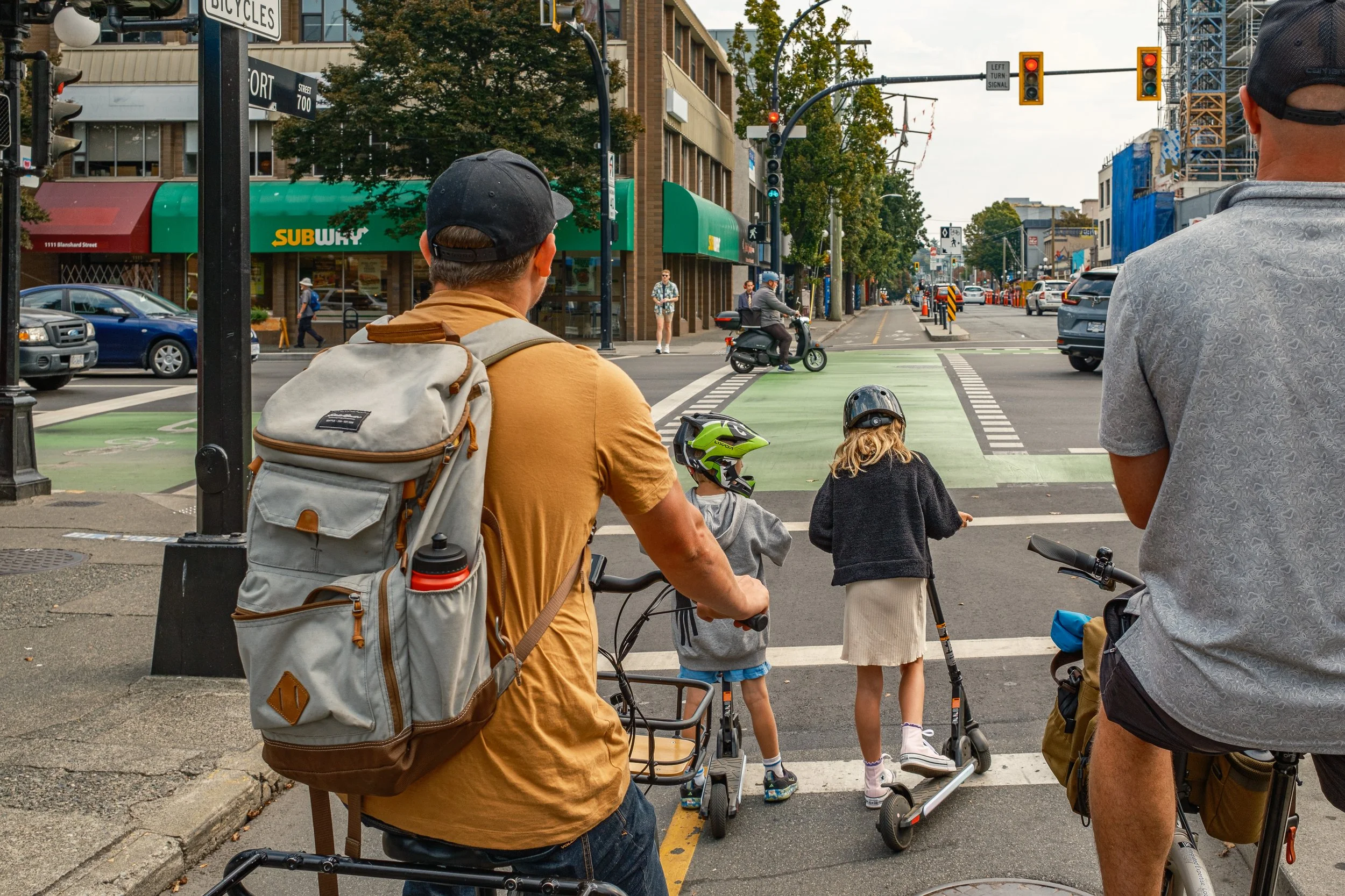 Family rolling along a protected bike lane in Victoria