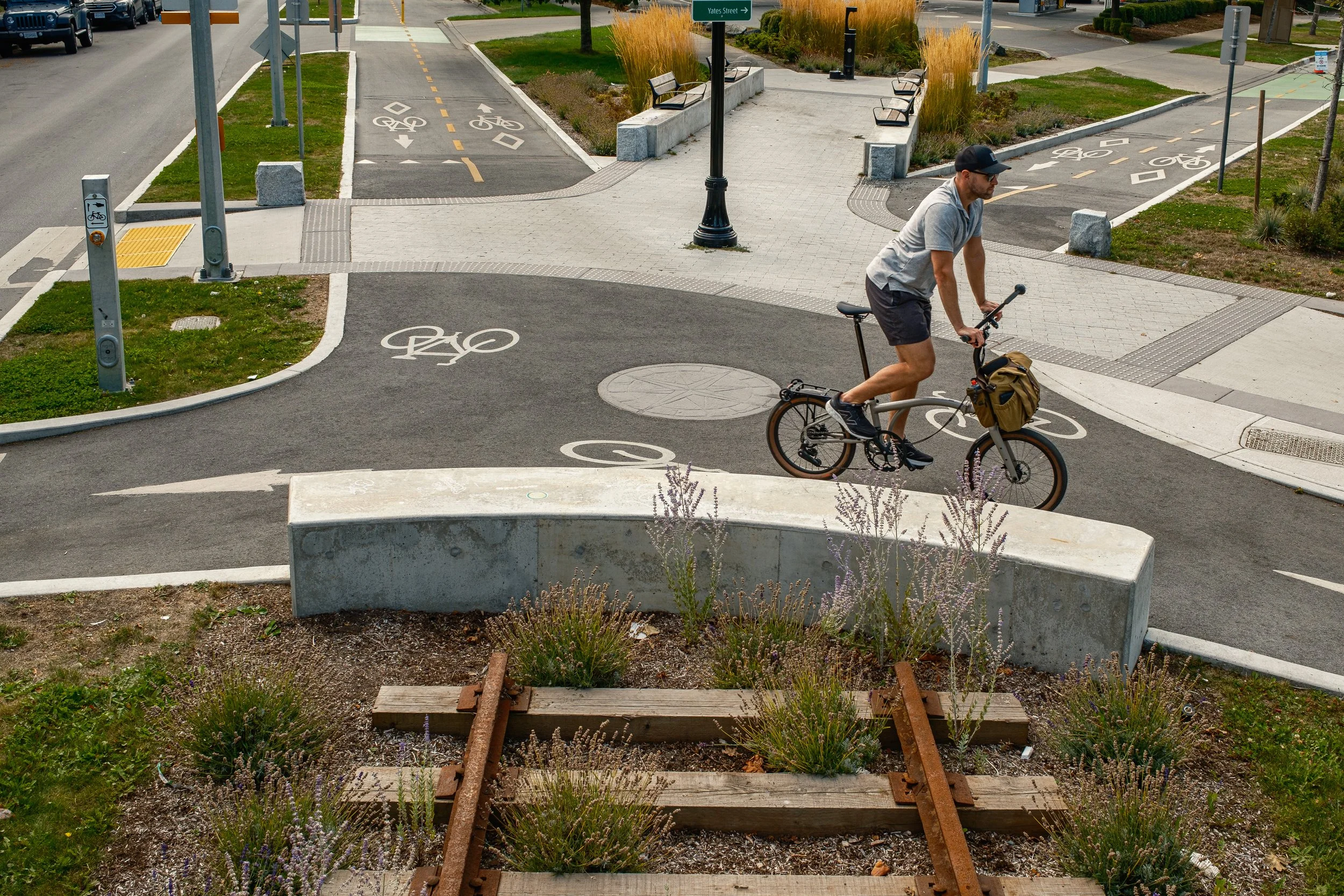 Man on Brompton G Line rolling through Fort Street Plaza