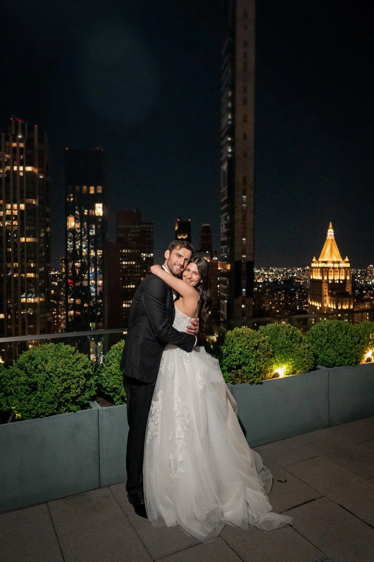 Nighttime rooftop couple portrait with city lights Virgin Hotels NYC