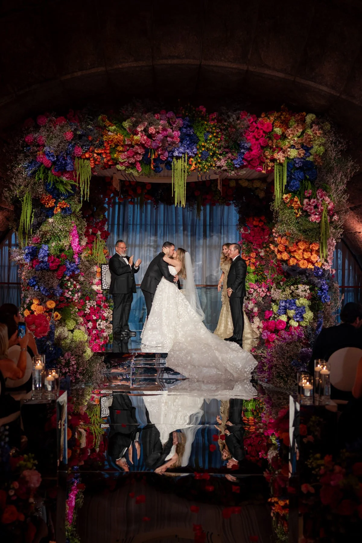 Wedding ceremony with mirror floor and floral arch at Guastavinos NYC