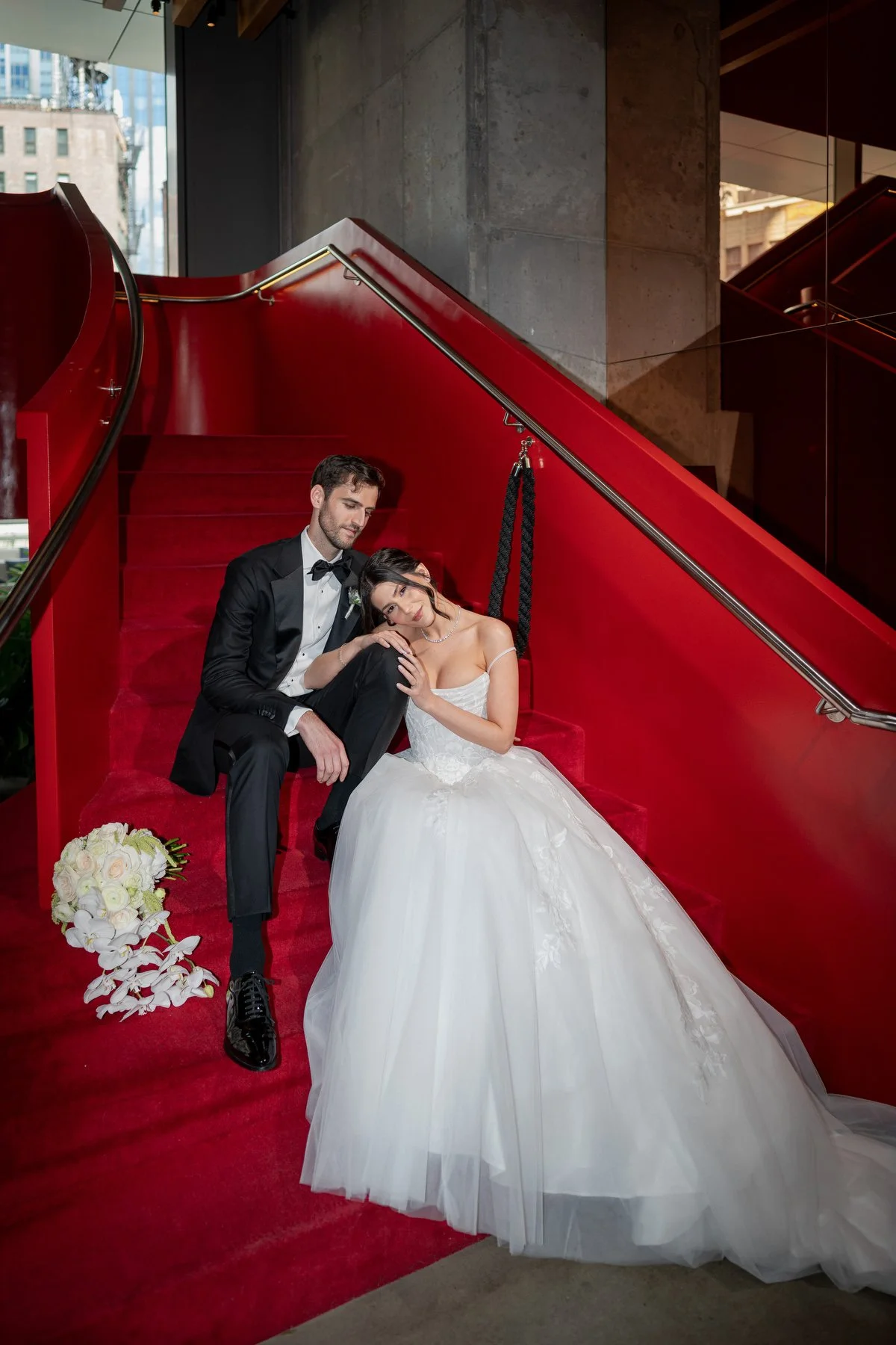Bride and groom on iconic red staircase Virgin Hotels New York City